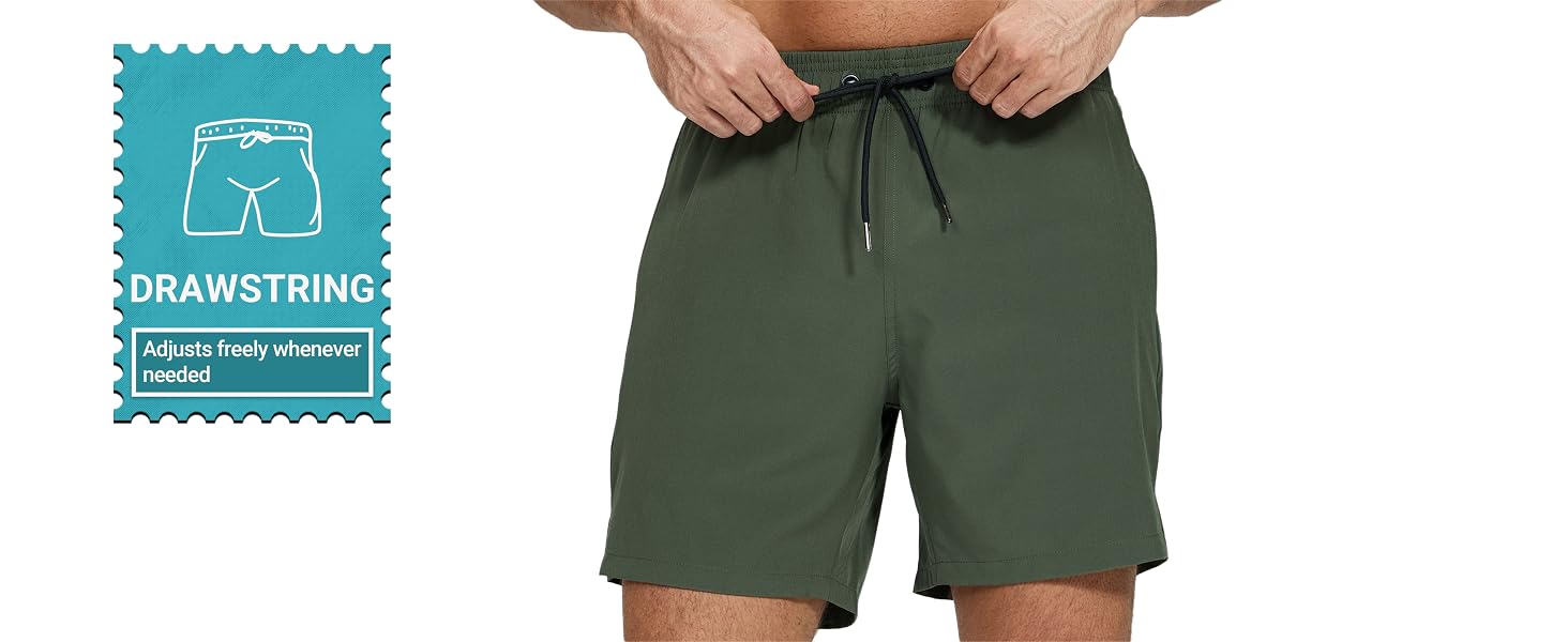 Men's olive green athletic shorts with drawstring waist. Hands adjusting the waistband. Inset icon shows shorts silhouette labeled 'DRAWSTRING'.